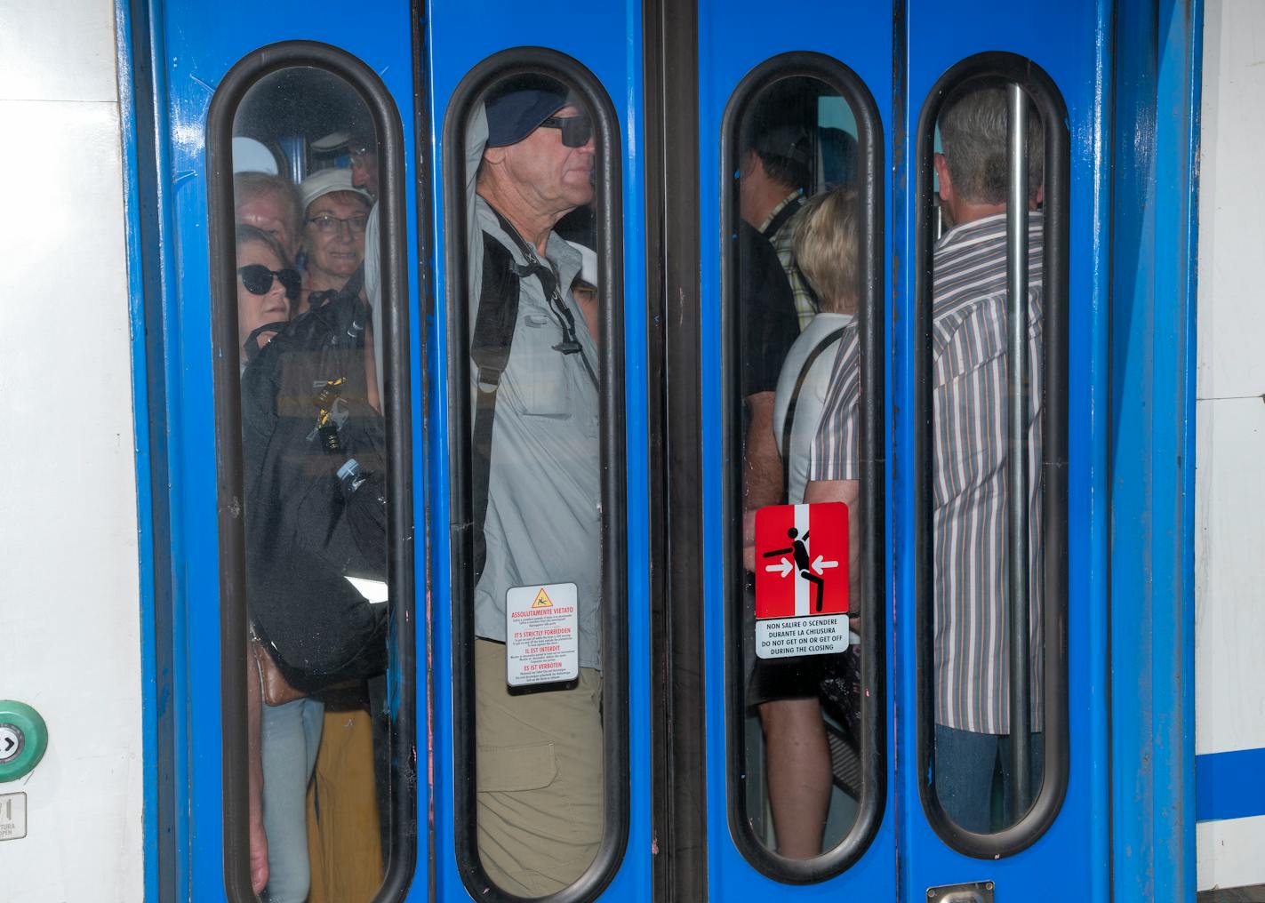 Tourists packed into a train car that will transport them between villages.